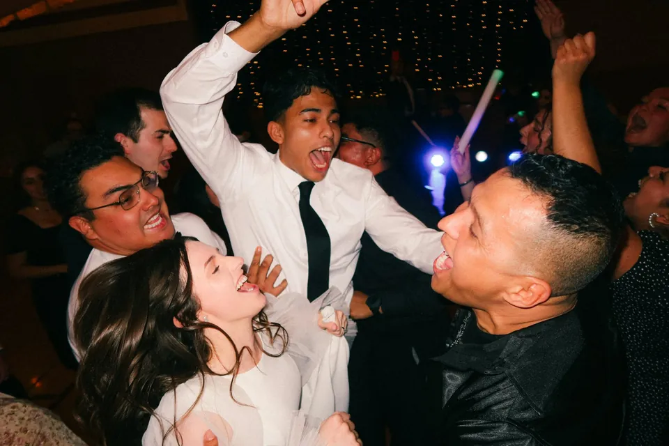 Guests mid-jump on the dance floor
