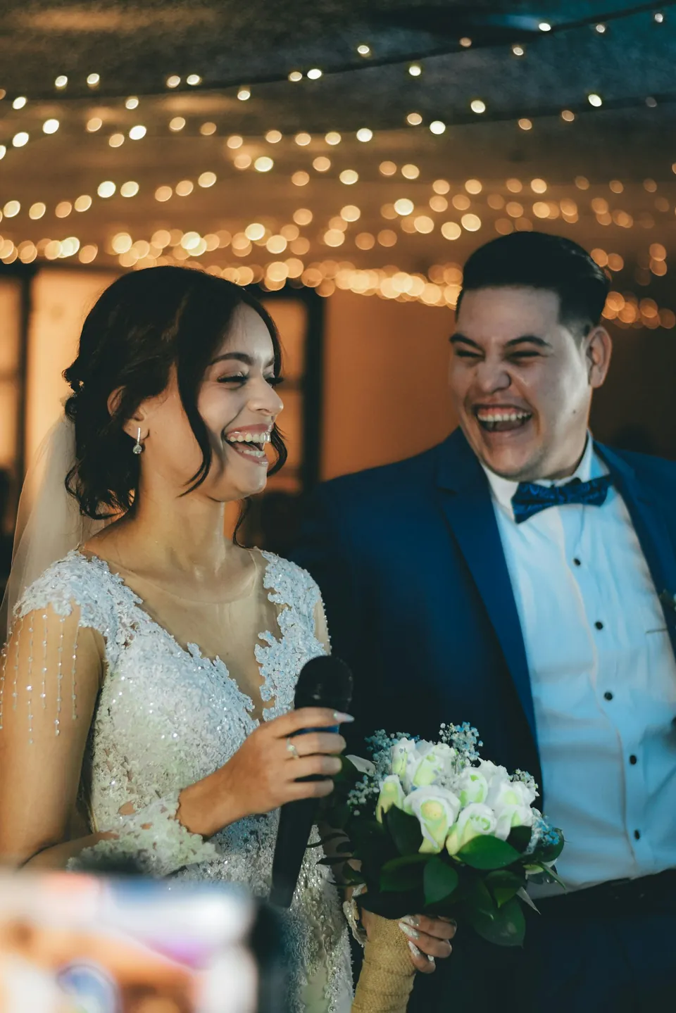 The couple laughing during the speeches