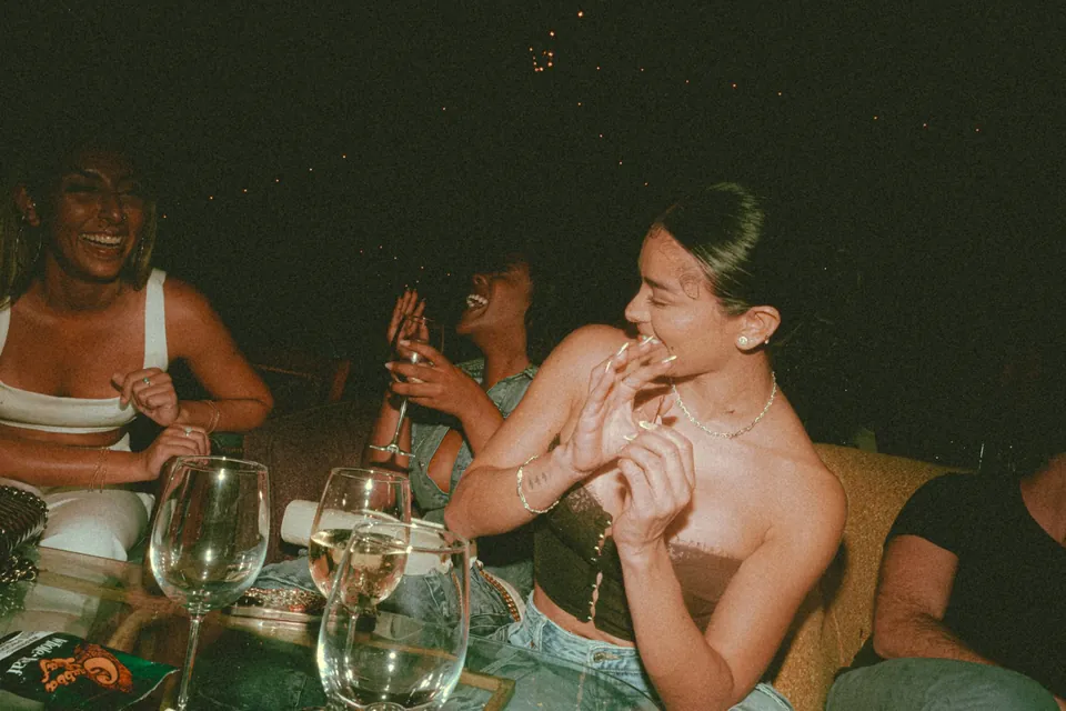 Friends laughing round a table on a night out